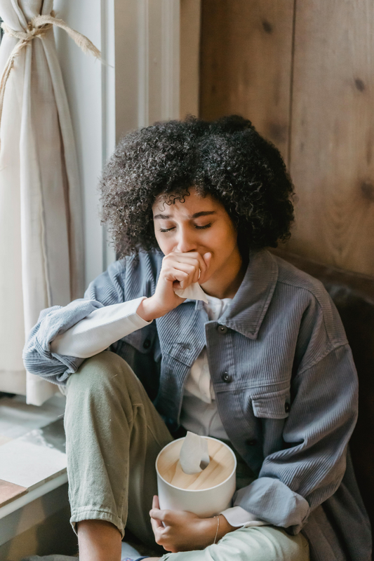 depressed-young-black-woman-sitting-on-hair-with-closed-eyes-and-crying