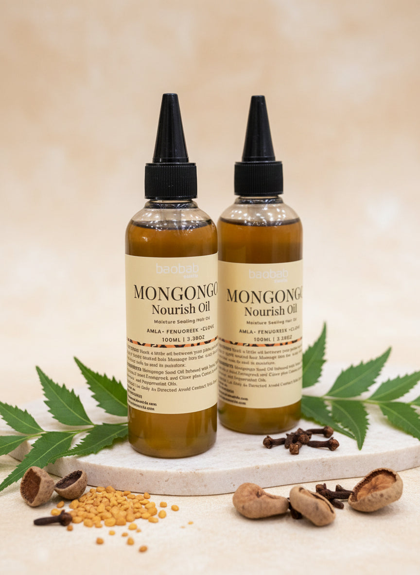 Two bottles of Mongongo Nourish Oil on a dark background