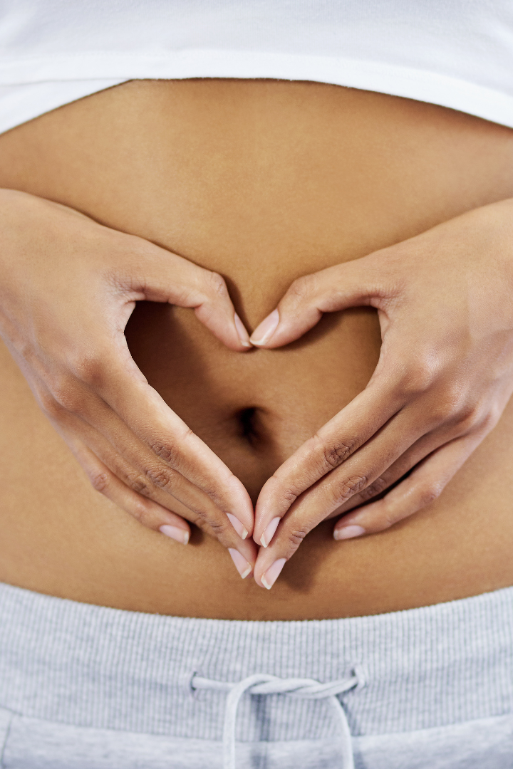 woman with hands on stomach