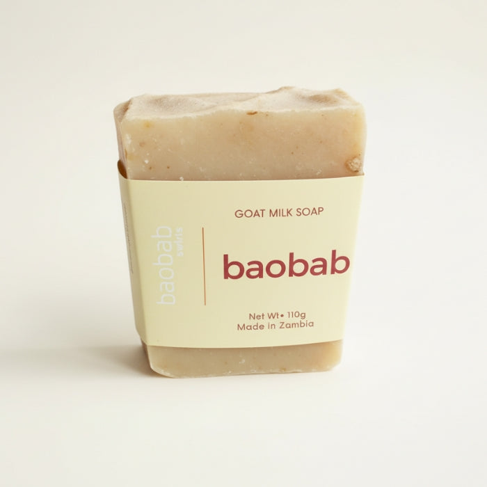 Bar of goat milk soap with 'baobab swirls' branding on a light background