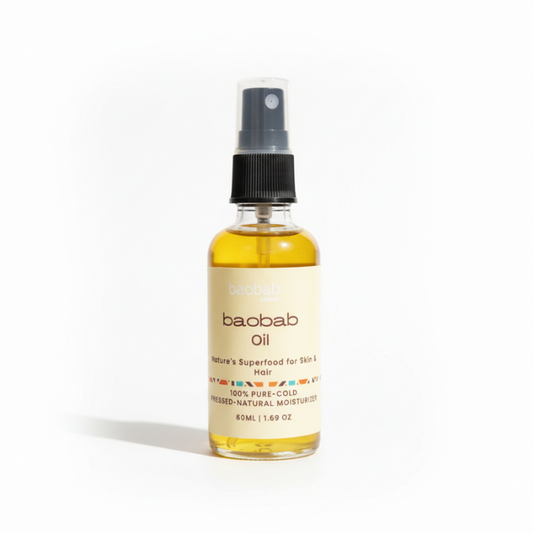 A bottle of Baobab Oil natural moisturizer with a black spray cap and a cream-colored label, set against a plain white background.