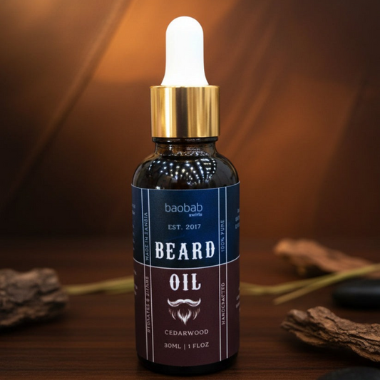 Bottle of Baobab swirls beard oil with a dropper on a wooden surface.