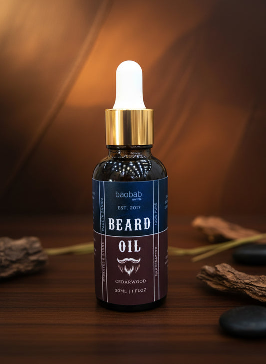 Bottle of baobab beard oil with dropper on a black background