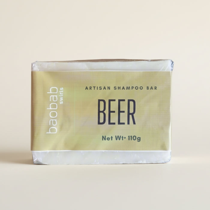 Beer shampoo bar packaging with 'baobab swirls' branding on a beige background