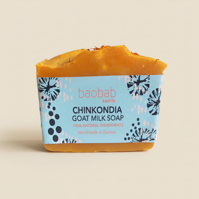 Chinkondia Bar of goat milk soap with a blue and yellow packaging on a beige background