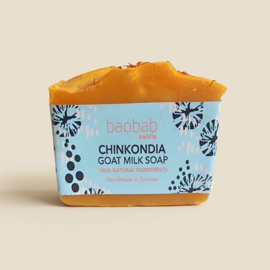 Chinkondia Bar of goat milk soap with a blue and yellow packaging on a beige background
