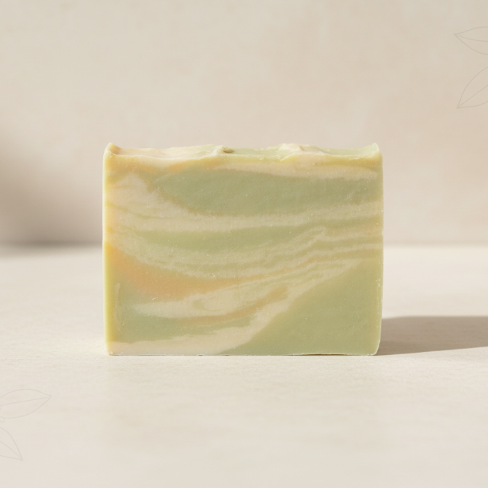 Marbled green and yellow soap bar on a beige background
