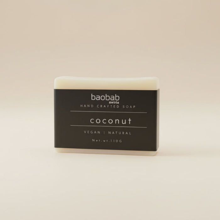 Bar of coconut soap with 'baobab swirls' branding on a beige background