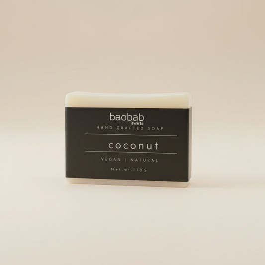 Bar of coconut soap with 'baobab swirls' branding on a beige background