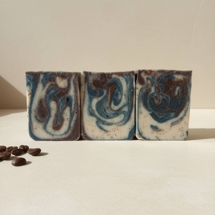 Handcrafted Coffee and Cream Goat Milk Soap bar with visible coffee grounds and charcoal swirls