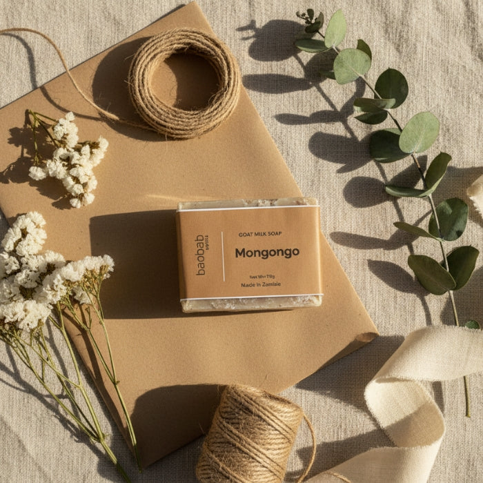 Bar of soap with 'baobab' branding on a brown paper background with flowers and twine.