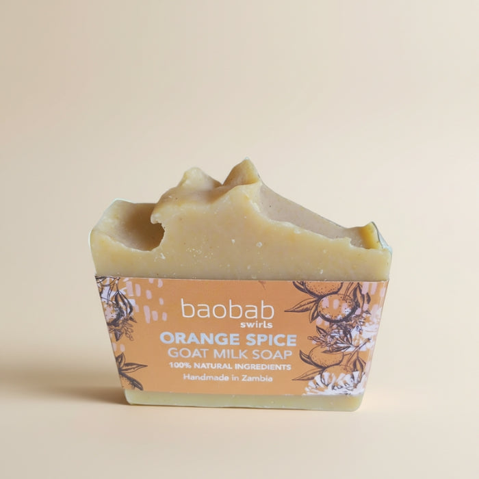 Bar of soap with 'baobab swirls' branding on a beige background