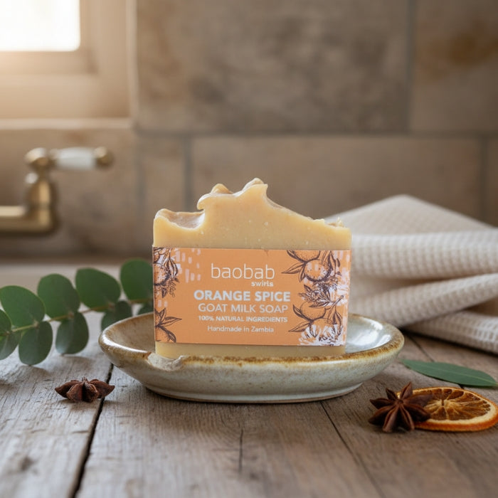 Bar of soap with 'baobab swirls' branding on a wooden surface with decorative elements.