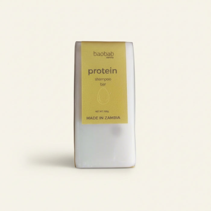 Protein shampoo bar packaging with 'baobab swirls' branding on a light beige background