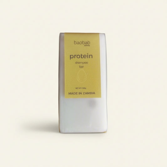 Protein shampoo bar packaging with 'baobab swirls' branding on a light beige background