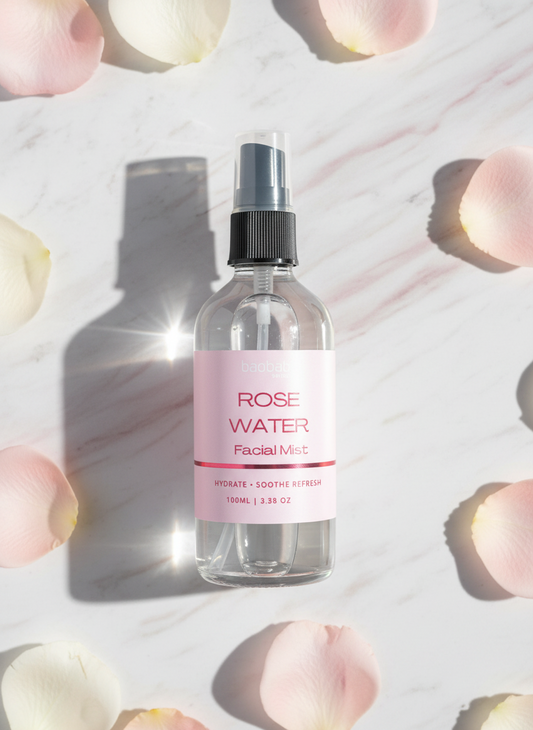 Facial mist bottle labeled 'Rose Water' on a light background with floral elements