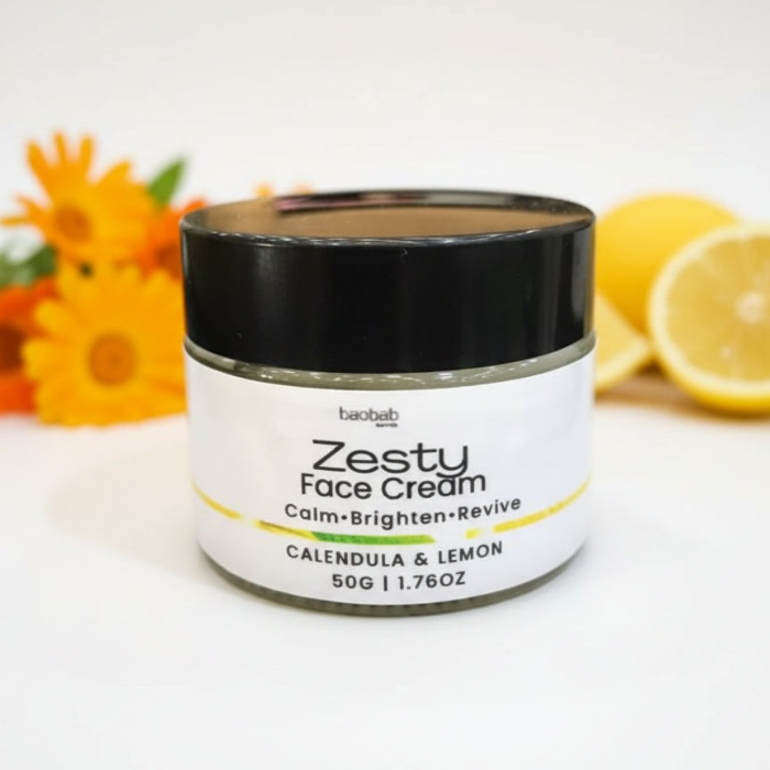 Jar of Zesty Face Cream with calendula and lemon in the background
